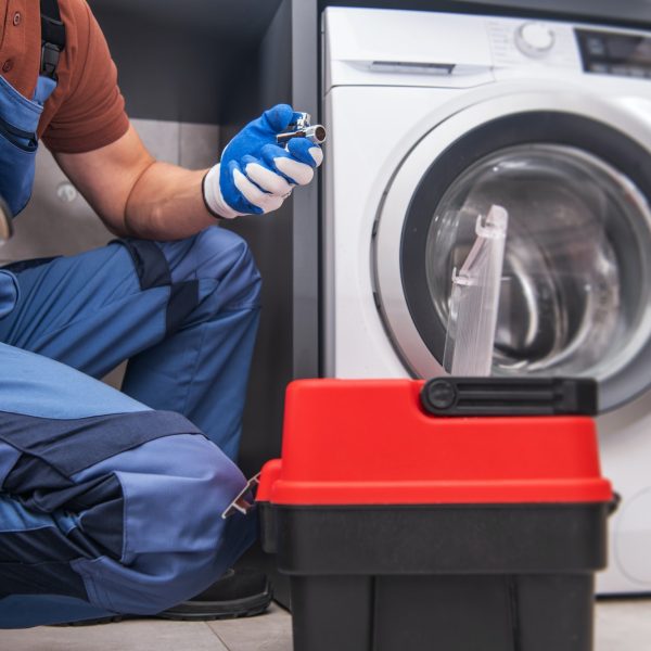 Professional Worker Installing Washing Machine